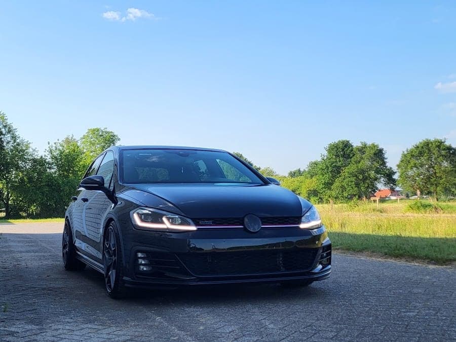 Schwarzer VW Golf GTI von vorn vor blauem Himmel